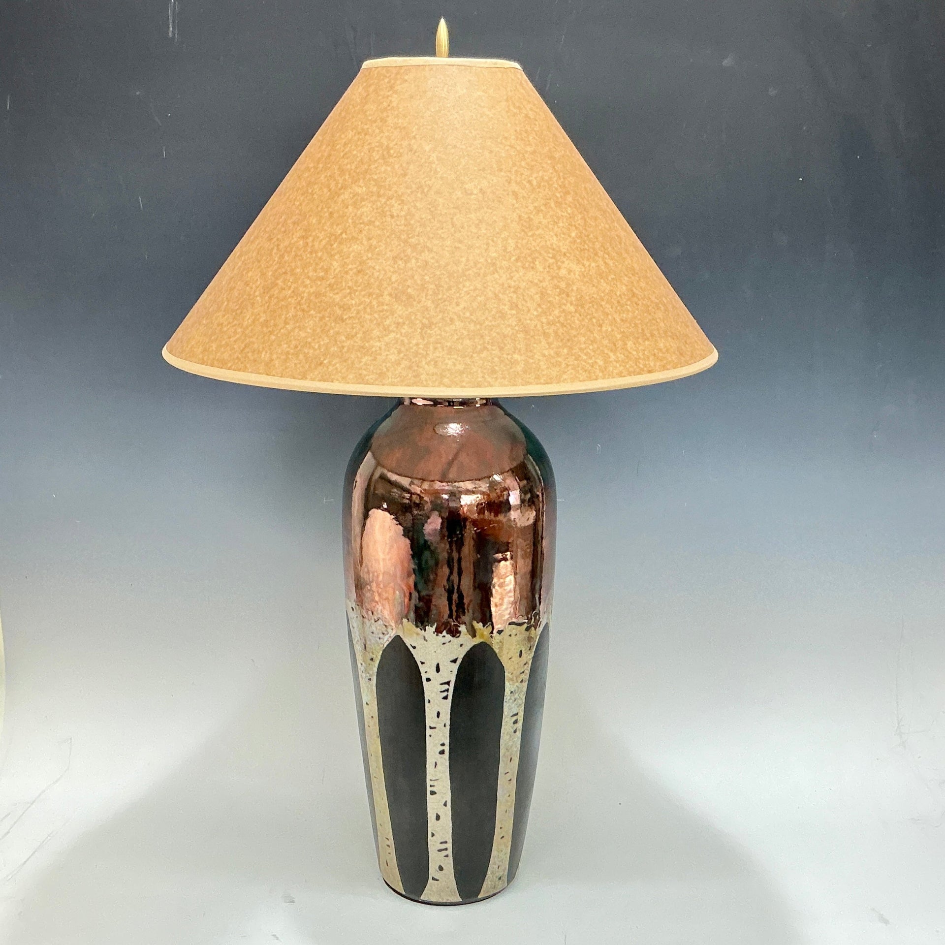Table lamp with aspen trees and beige shade on a gray background