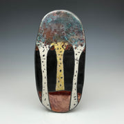 raku tile with an image of aspen trees on a black background