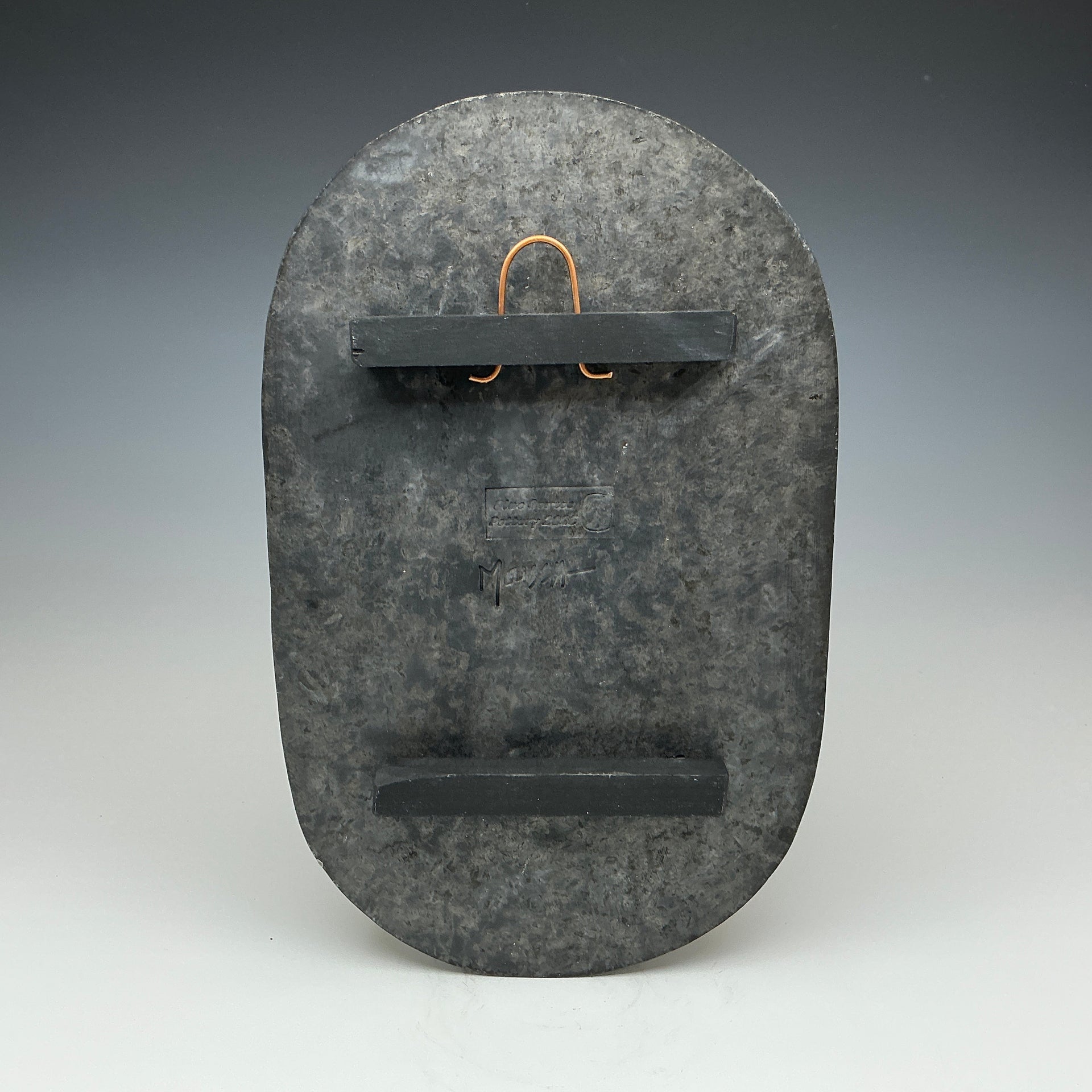 Back of large oval Raku tile