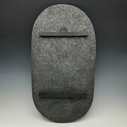 Dark gray stone wall art piece with a subtle pattern on a gradient background