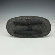 Back of skinny oval Raku tile Showing the hanger