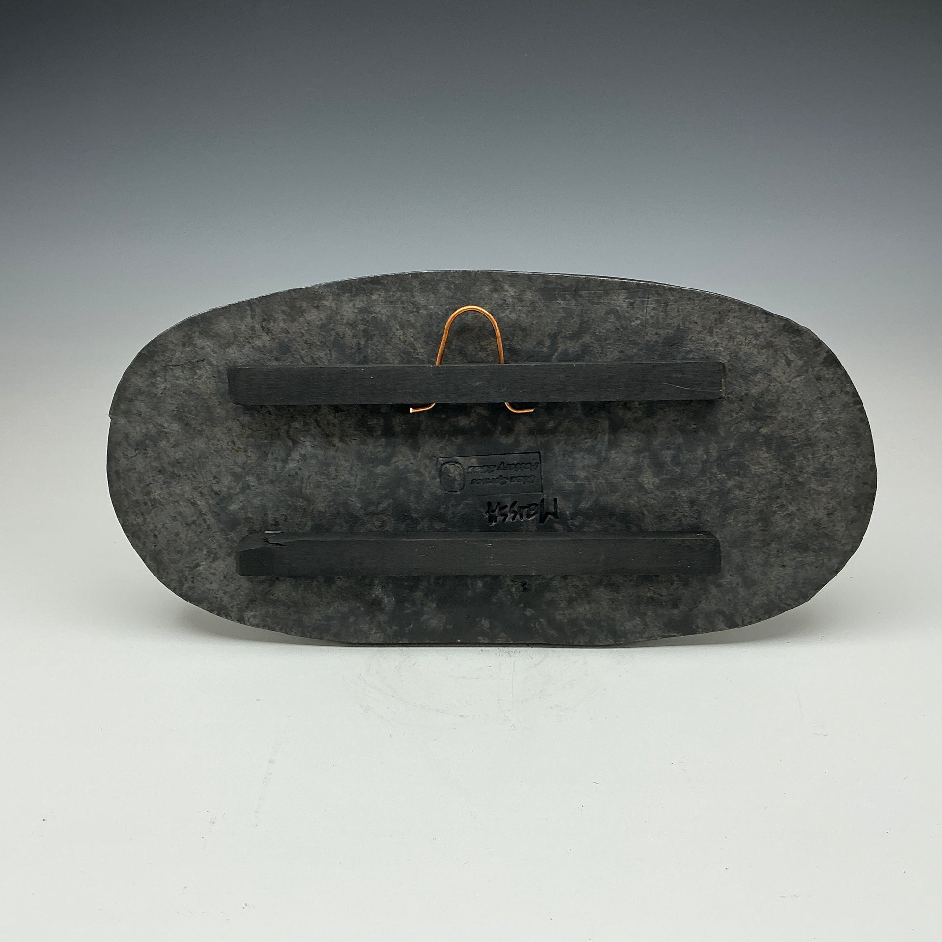 Back of skinny oval Raku tile Showing the hanger