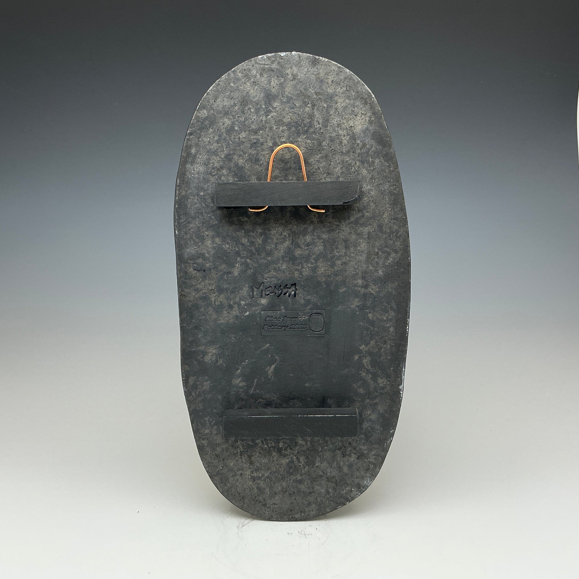 Back of the tall oval Raku tile Showing the hanger