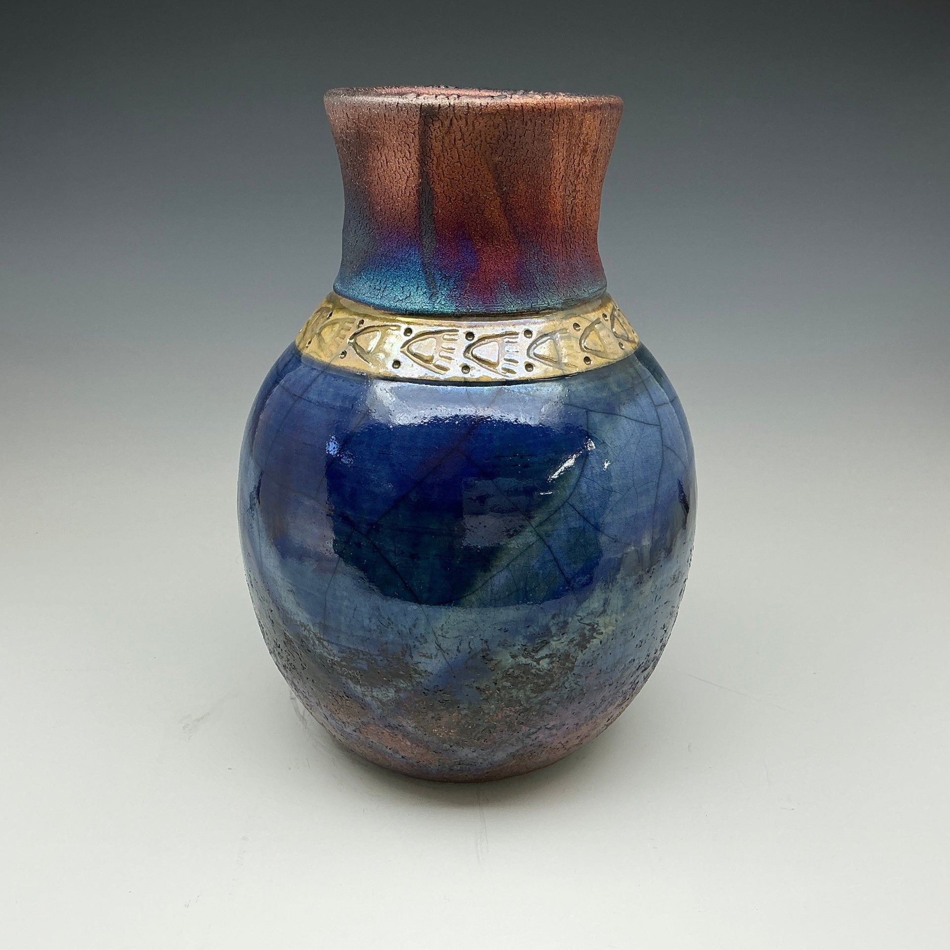 Raku vase with blue and gold colors