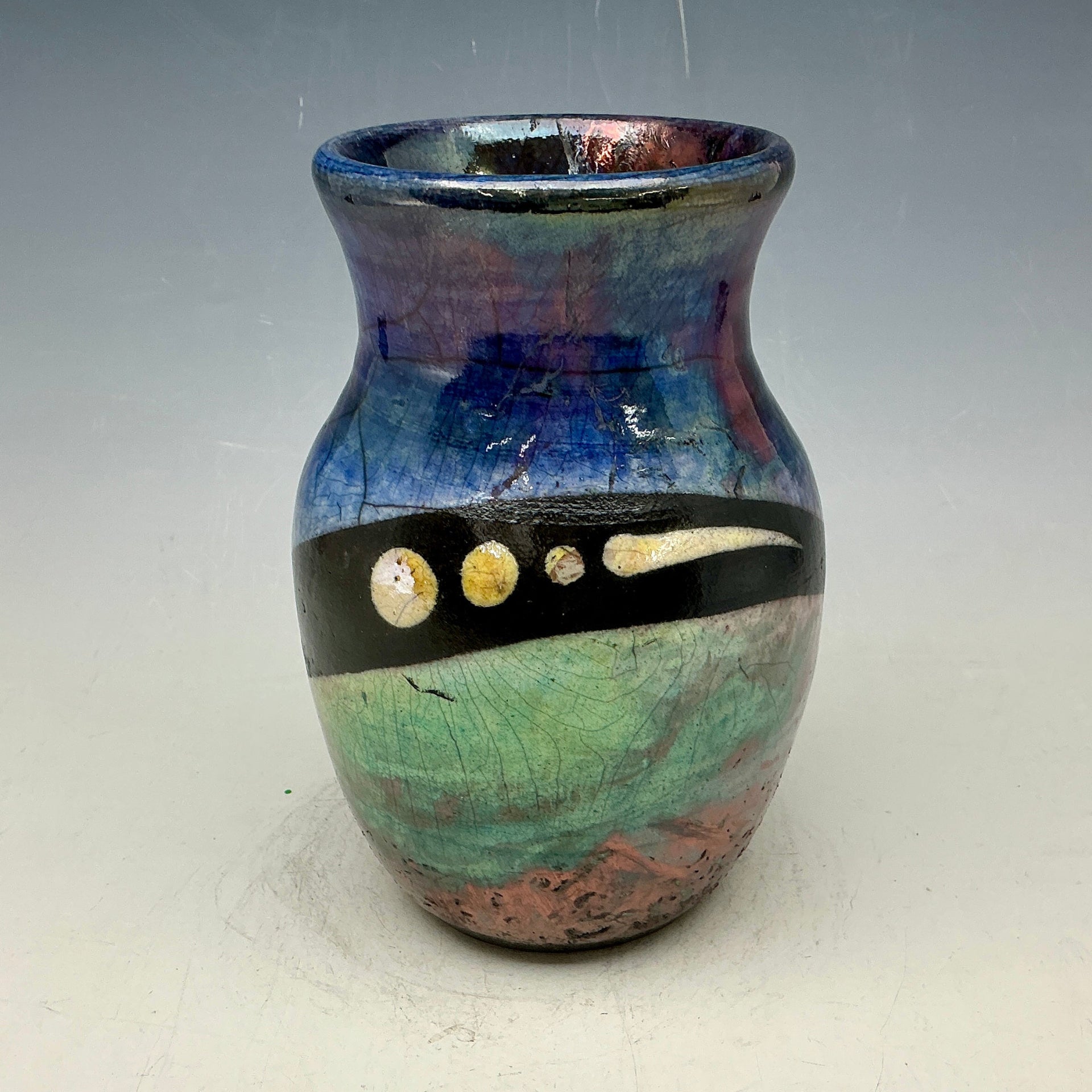 Blue and teal vase with gold accents