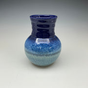 Blue ceramic vase on a gray background