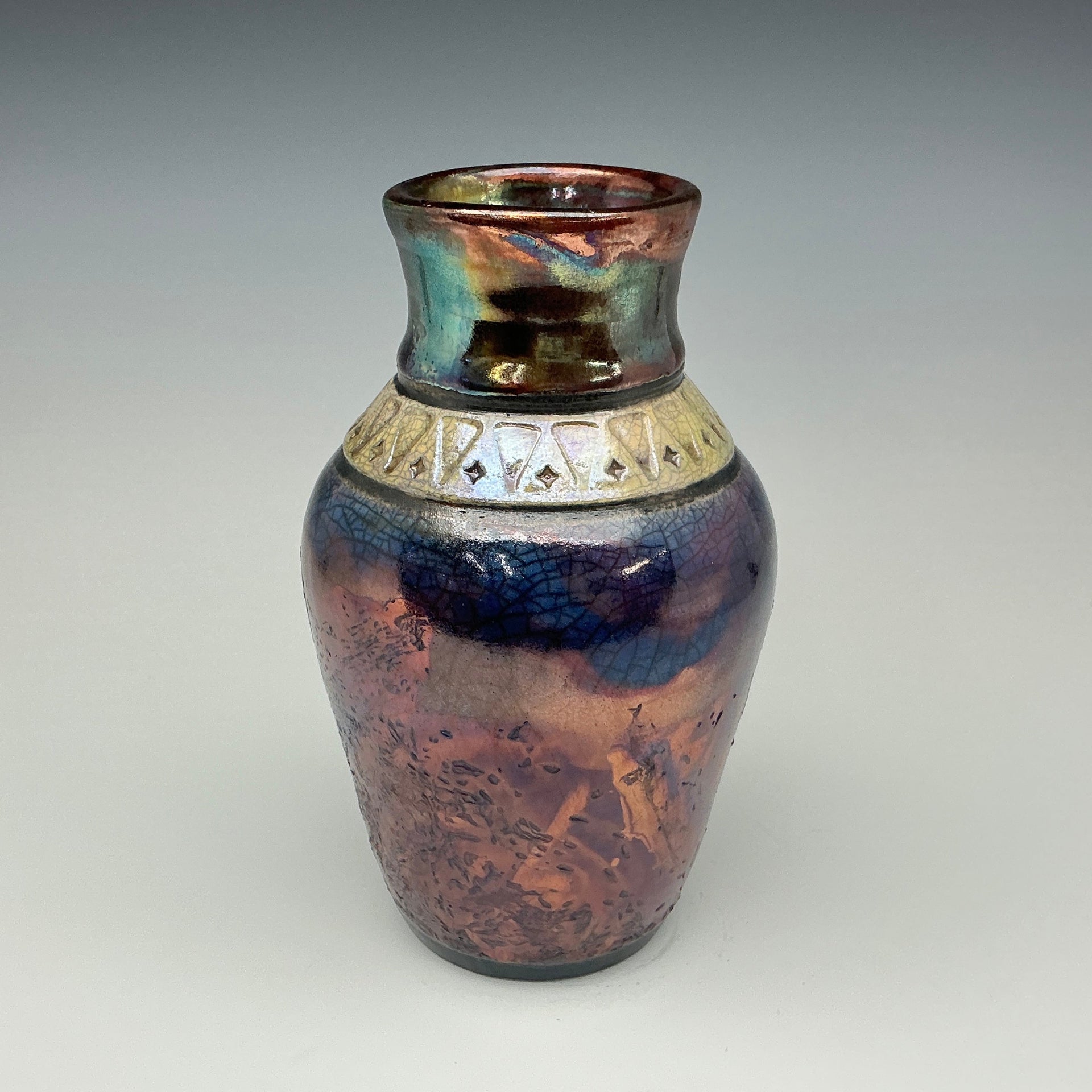 Blue vase with a gold necklace