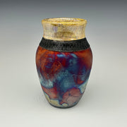 Ceramic vase with multicolored glaze on a gray background