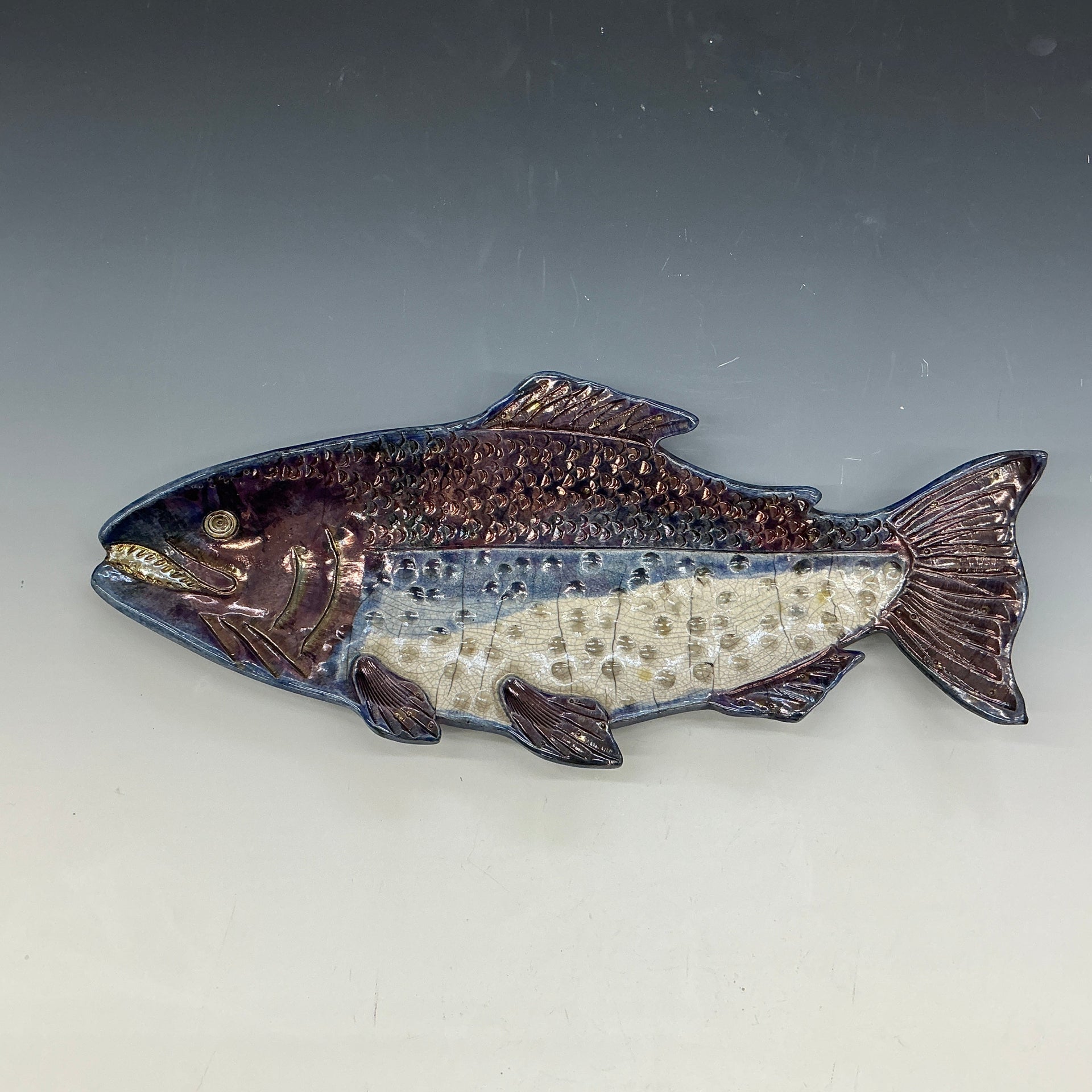 Decorative fish sculpture on a gray background