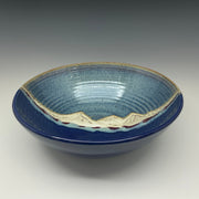 Large ceramic bowl with a mountain on a grey background