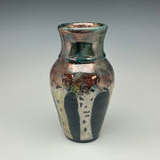 Ceramic vase with multicolored glaze on a gray background