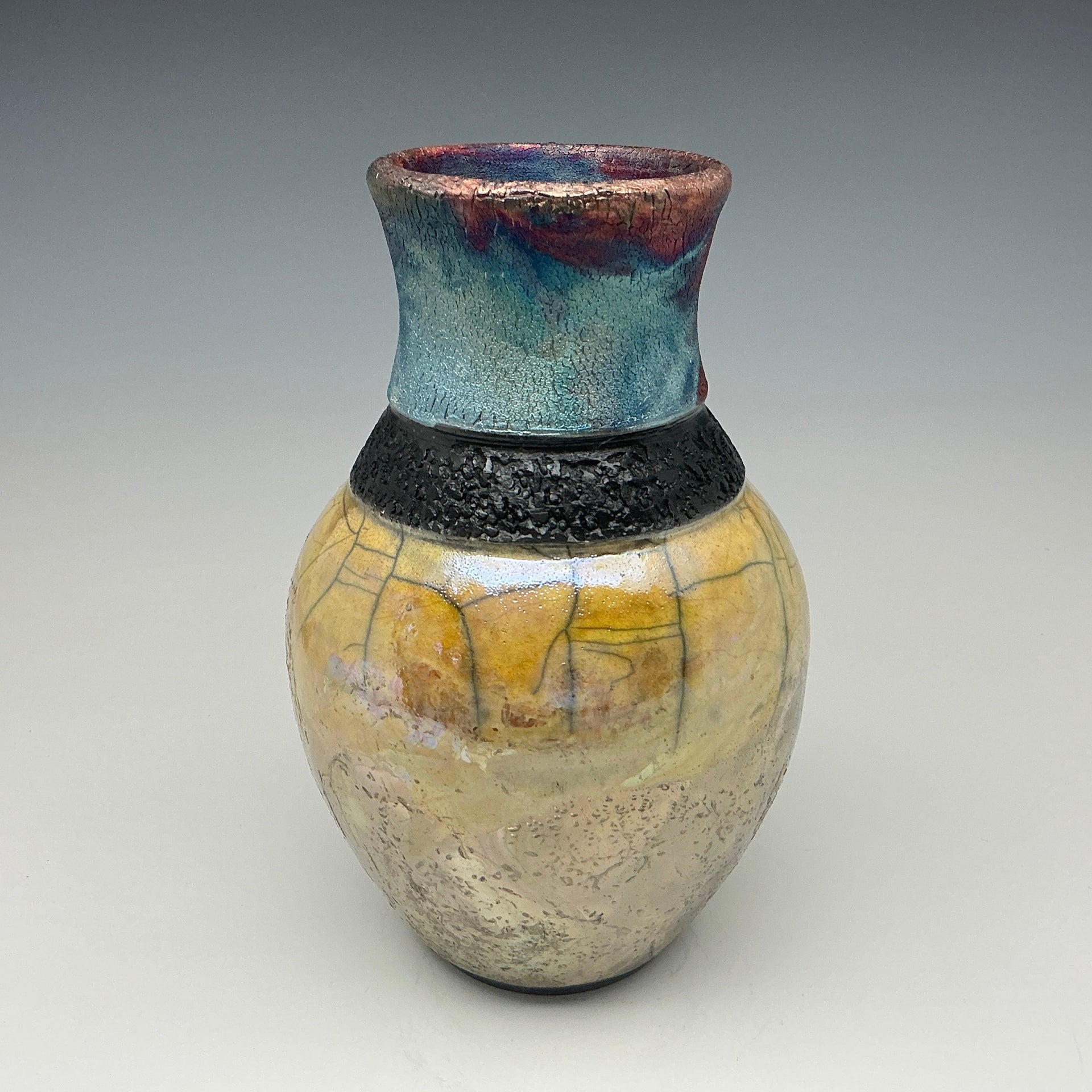 Sparkle and gold bottle with a black necklace