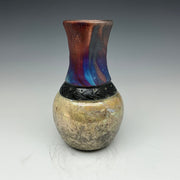 raku vase with a multicolored top and gold bottom with a necklace of black bear prints