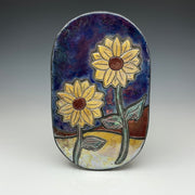 decorative wall tile with an image of sunflowers on a blue and gold background 