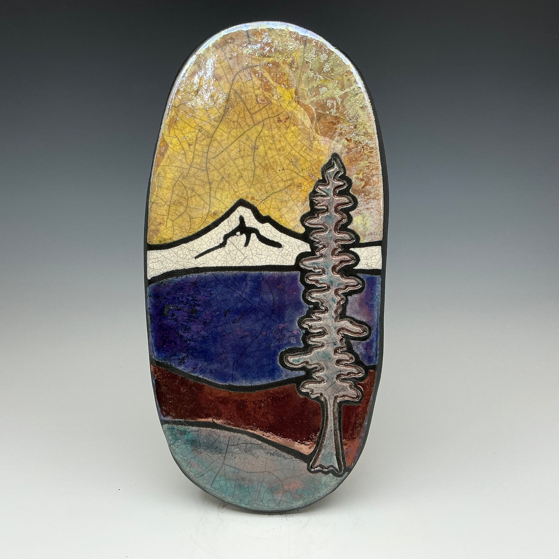 sunny day at the lake with mountains in the background on it.