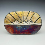 A decorative wall tile with an image of a Sunset over the 3 Sisters Mountains on it