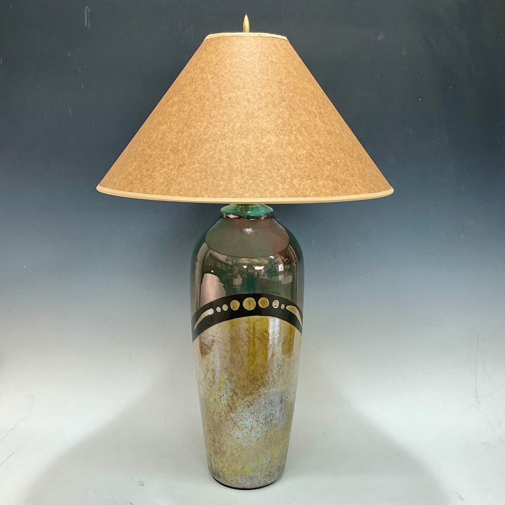 Decorative lamp with a textured shade on a gray background