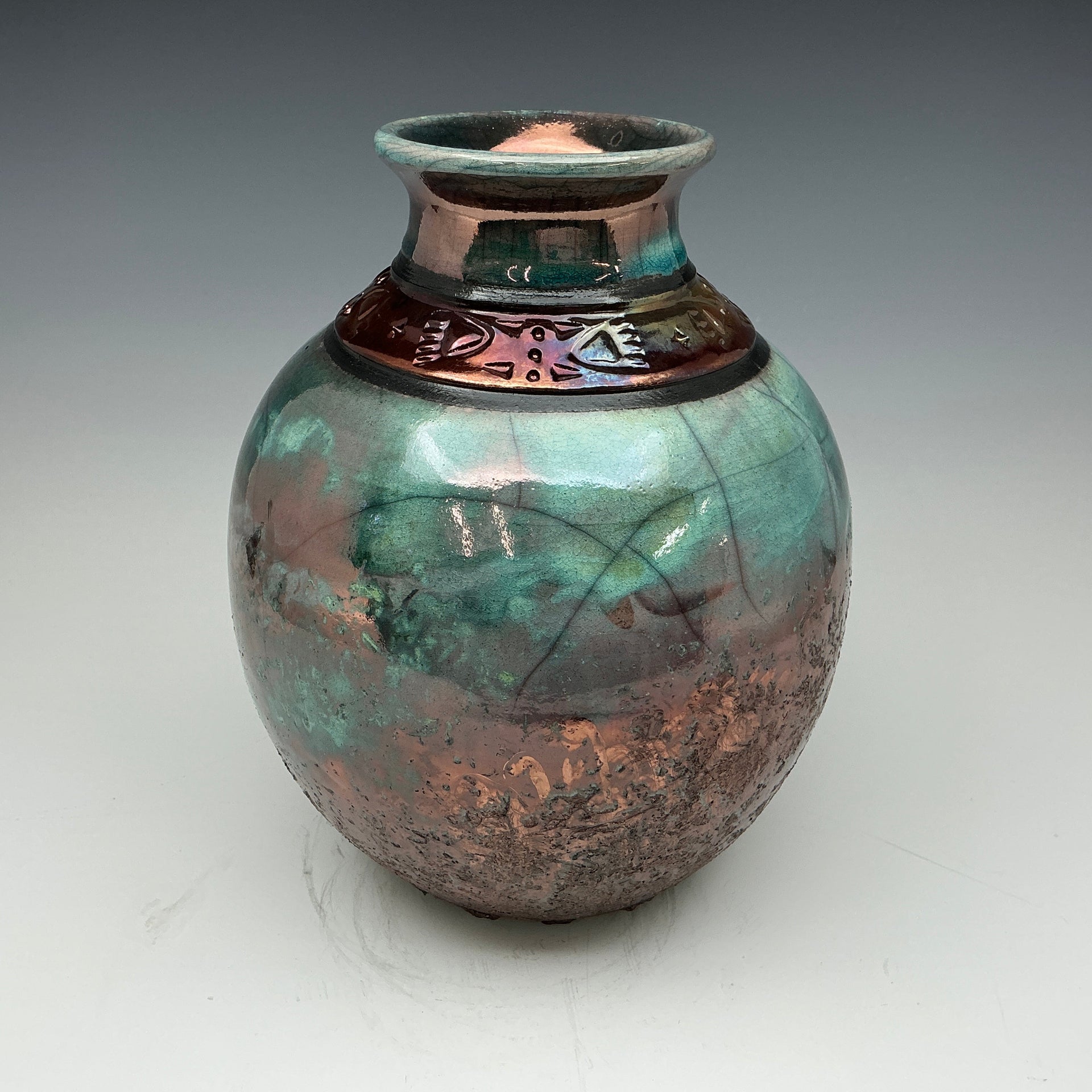 raku vase with teal and copper glazes
